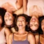Mulheres com diferentes tonalidades de pele sorrindo lado a lado